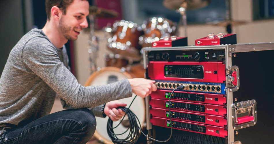 Luke Matyas, a student at the Music Technology program at Capital University, interacts with a gear setup including RedNet components from Focusrite